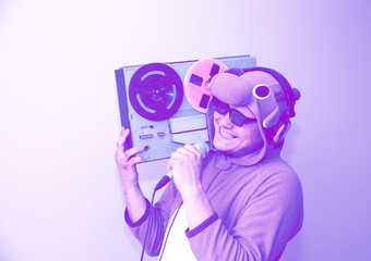 Man in cosplay costume of a cow singing karaoke. Guy in the animal pyjamas sleepwear holding...