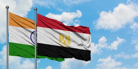 India and Egypt flag waving in the wind against white cloudy blue sky together. Diplomacy concept, international relations.