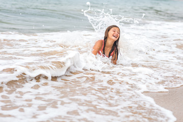 young girl playing in the Pacific Ocean