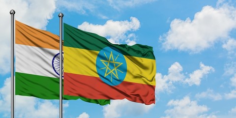 India and Ethiopia flag waving in the wind against white cloudy blue sky together. Diplomacy concept, international relations.
