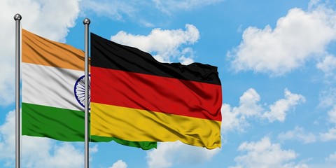 India and Germany flag waving in the wind against white cloudy blue sky together. Diplomacy concept, international relations.