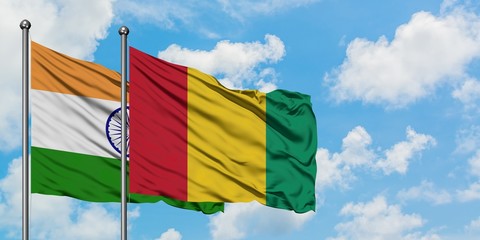 India and Guinea flag waving in the wind against white cloudy blue sky together. Diplomacy concept, international relations.