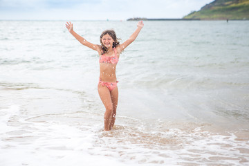 young girl splashing in the Pacific Ocean