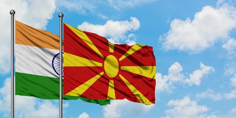 India and Macedonia flag waving in the wind against white cloudy blue sky together. Diplomacy concept, international relations.