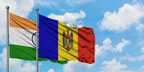 India and Moldova flag waving in the wind against white cloudy blue sky together. Diplomacy concept, international relations.