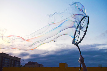 Soap bubbles show at a children's holiday. Huge soap bubble.