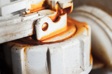 The mechanism for flushing the toilet is covered with a coating of hard water. Corrosion. A lever connected to the float to shut off the water supply.