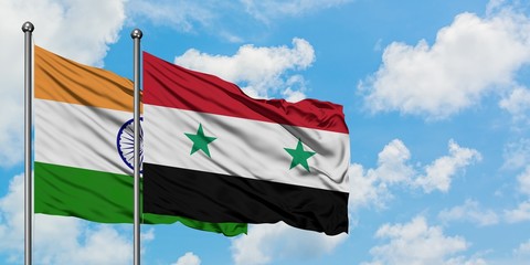 India and Syria flag waving in the wind against white cloudy blue sky together. Diplomacy concept,...