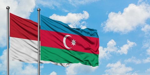 Iraq and Azerbaijan flag waving in the wind against white cloudy blue sky together. Diplomacy concept, international relations.