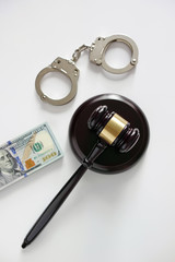 Gavel, cuffs and dollar bills