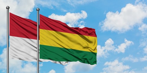 Iraq and Bolivia flag waving in the wind against white cloudy blue sky together. Diplomacy concept, international relations.