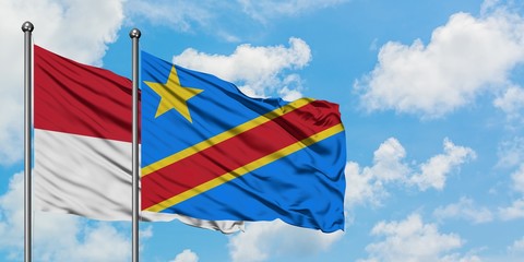 Iraq and Congo flag waving in the wind against white cloudy blue sky together. Diplomacy concept, international relations.