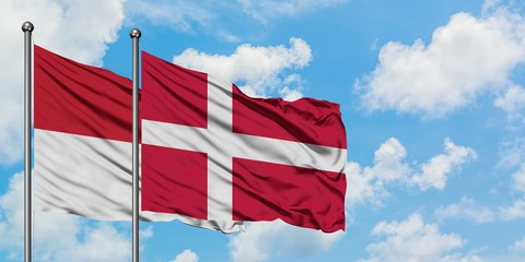 Iraq and Denmark flag waving in the wind against white cloudy blue sky together. Diplomacy concept,...