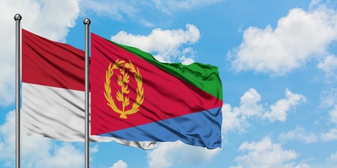 Iraq and Eritrea flag waving in the wind against white cloudy blue sky together. Diplomacy concept, international relations.