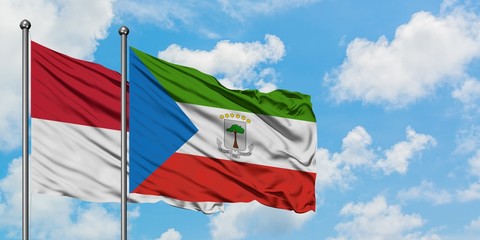 Iraq and Equatorial Guinea flag waving in the wind against white cloudy blue sky together. Diplomacy concept, international relations.