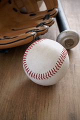 Old well used baseball with mitt and bat