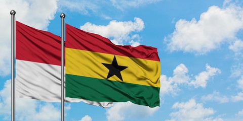 Iraq and Ghana flag waving in the wind against white cloudy blue sky together. Diplomacy concept, international relations.