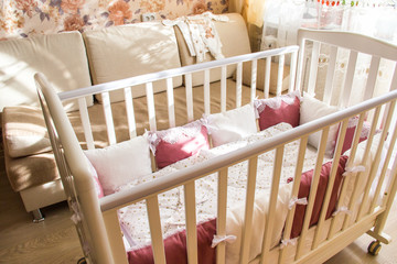 Baby bed crib with white and Burgundy color pillows with laces