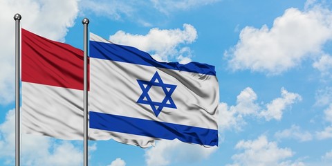 Iraq and Israel flag waving in the wind against white cloudy blue sky together. Diplomacy concept, international relations.