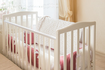 Baby bed crib with white and Burgundy color pillows with laces