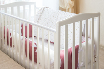 Baby bed crib with white and Burgundy color pillows with laces