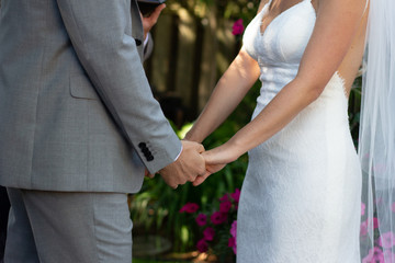 bride and groom holding hands