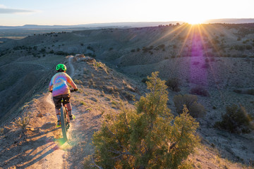 A young boy riding his mountain bike on the trails in Fruita, Colorado