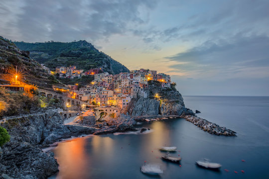 Houses on mountain beside sea