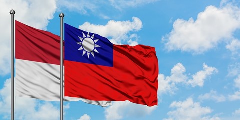 Naklejka na ściany i meble Iraq and Taiwan flag waving in the wind against white cloudy blue sky together. Diplomacy concept, international relations.
