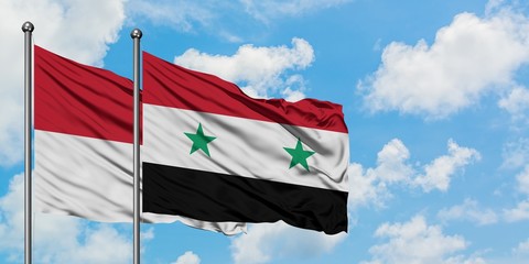 Iraq and Syria flag waving in the wind against white cloudy blue sky together. Diplomacy concept,...