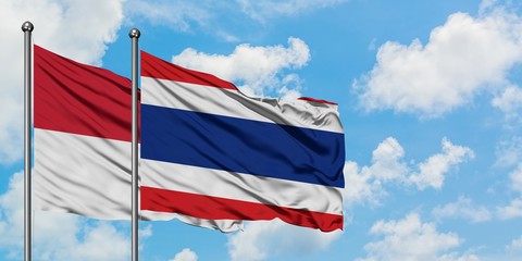 Iraq and Thailand flag waving in the wind against white cloudy blue sky together. Diplomacy concept, international relations.