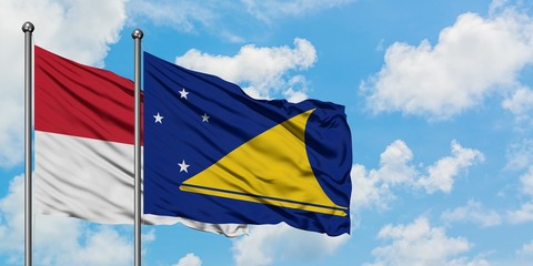 Iraq and Tokelau flag waving in the wind against white cloudy blue sky together. Diplomacy concept, international relations.