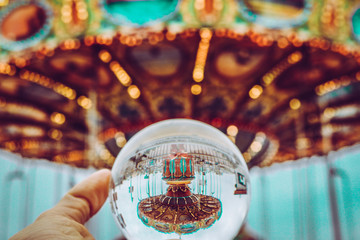 Multicolored carousel ride on lensball photography