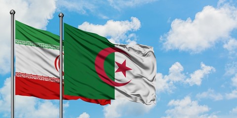 Iran and Algeria flag waving in the wind against white cloudy blue sky together. Diplomacy concept,...