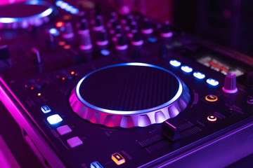 DJ playing music.Midi controller turntable.New digital technology for mixing audio tracks.Sound mixer with turntables.Disc jockey mix music at party on summer festival