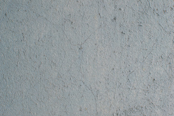 An old concrete wall painted blue and gray