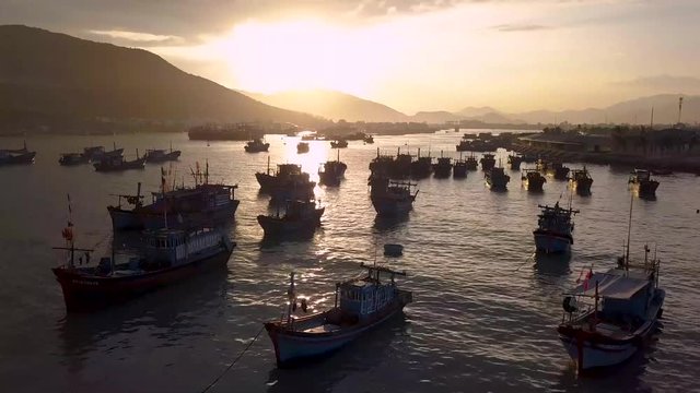 Drone shoots video of fisherman boat sunset and mountain view