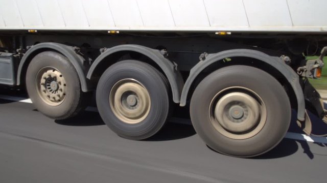 driving next to truck on a highway, big wheels spinning