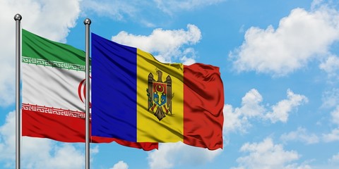Iran and Moldova flag waving in the wind against white cloudy blue sky together. Diplomacy concept, international relations.