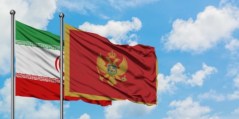 Iran and Montenegro flag waving in the wind against white cloudy blue sky together. Diplomacy concept, international relations.
