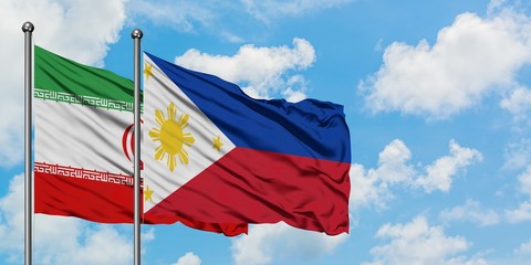 Iran and Philippines flag waving in the wind against white cloudy blue sky together. Diplomacy concept, international relations.