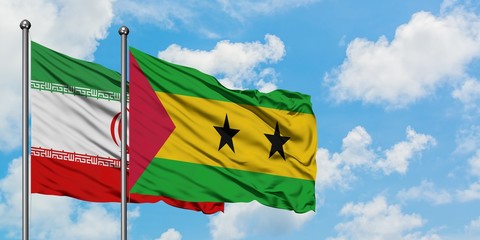 Iran and Sao Tome And Principe flag waving in the wind against white cloudy blue sky together. Diplomacy concept, international relations.