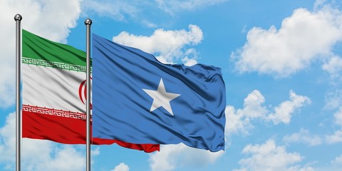 Iran and Somalia flag waving in the wind against white cloudy blue sky together. Diplomacy concept, international relations.