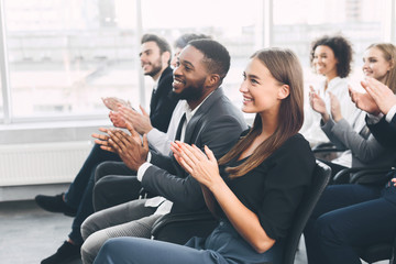 Diverse business team greeting speaker with applause