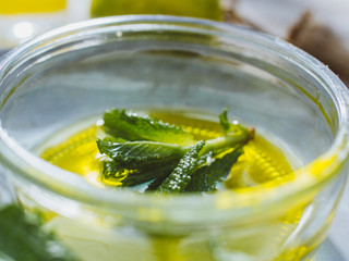 Modern apothecary on a naural wooden desk with herbs and wildflowers showing a minimalist organic lyfestyle.