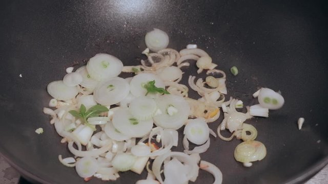 Sliced onion fried in a pan