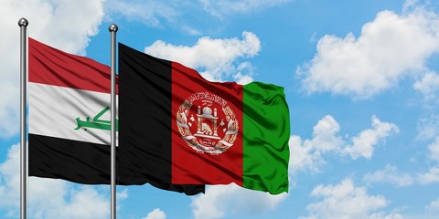 Iraq and Afghanistan flag waving in the wind against white cloudy blue sky together. Diplomacy...