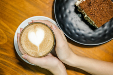 Woman hold cup with coffee in her hands