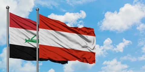 Iraq and Austria flag waving in the wind against white cloudy blue sky together. Diplomacy concept, international relations.