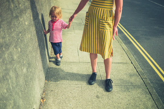 Mother and toddler walking on the street